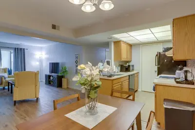 a kitchen and dining room with a vase of flowers on a table at Toledo Vacation Rental about 8 Mi to Downtown! in Toledo