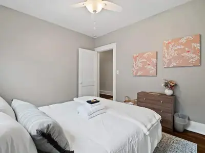 a white bedroom with a bed and a ceiling fan at 19th Century 'Cleveland Double' - Walk To Beach in Cleveland