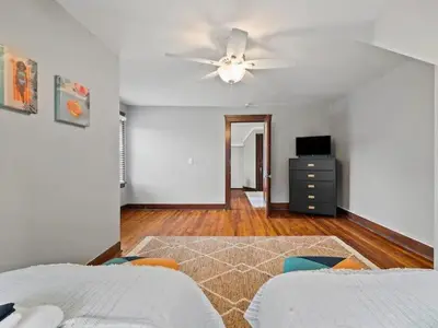 a bedroom with two beds and a ceiling fan at 19th Century 'Cleveland Double' - Walk To Beach in Cleveland