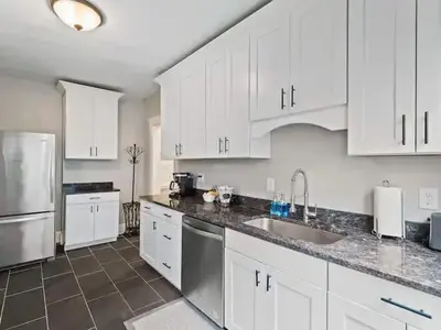 a kitchen with white cabinets and stainless steel appliances at 19th Century 'Cleveland Double' - Walk To Beach in Cleveland