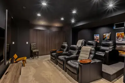 a living room with black leather furniture and a flat screen tv at Luxuary Tremont Home - Movie Room, Pet & Baby Friendly in Cleveland