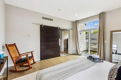 a bedroom with a bed and a chair and a window at Luxuary Tremont Home - Movie Room, Pet & Baby Friendly in Cleveland
