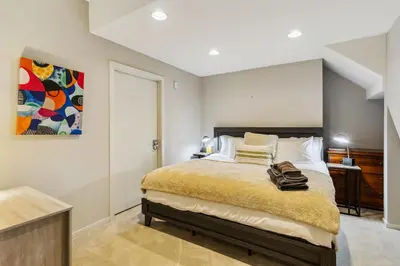 a bedroom with a bed and a painting on the wall at Luxuary Tremont Home - Movie Room, Pet & Baby Friendly in Cleveland