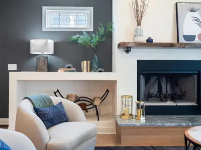 a living room with a chair and a fireplace at The Emerald Manor in Cleveland