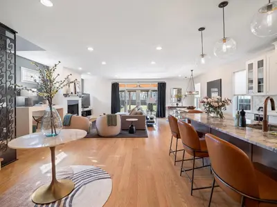 a kitchen and living room with a table and chairs at The Emerald Manor in Cleveland