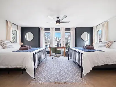 a bedroom with two beds and a ceiling fan at The Emerald Manor in Cleveland