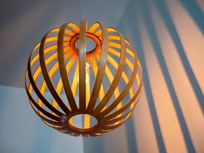a yellow and orange chandelier hanging from a ceiling at The Emerald Manor in Cleveland
