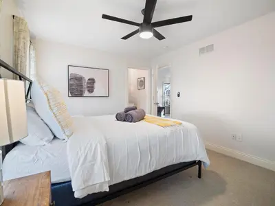 a bedroom with a bed with a ceiling fan at The Emerald Manor in Cleveland