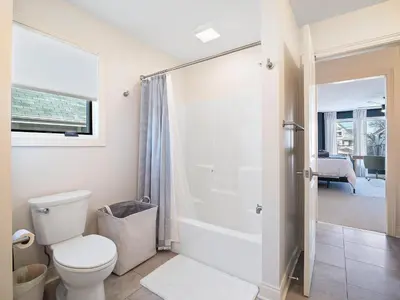 a bathroom with a toilet and a shower at The Emerald Manor in Cleveland