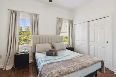 a bedroom with a bed and two windows at Newly Renovated Tremont Treasure I Cozy + Modern in Cleveland