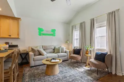 a living room with a couch and a table at Newly Renovated Tremont Treasure I Cozy + Modern in Cleveland