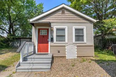 a tiny house with a red door in a yard at Newly Renovated Tremont Treasure I Cozy + Modern in Cleveland