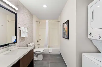 a white bathroom with a toilet and a sink at Everhome Suites Lexington - Horse Park in Lexington