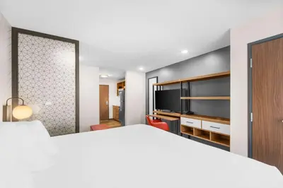a bedroom with a bed and a flat screen tv at Everhome Suites Lexington - Horse Park in Lexington