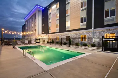 a hotel swimming pool in front of a building at Everhome Suites Lexington - Horse Park in Lexington