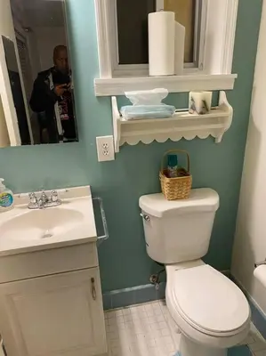 a bathroom with a toilet and a sink and a mirror at Lovely home away from home 4BR 3ba in Cincinnati