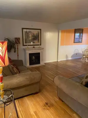 a living room with a couch and a fireplace at Lovely home away from home 4BR 3ba in Cincinnati