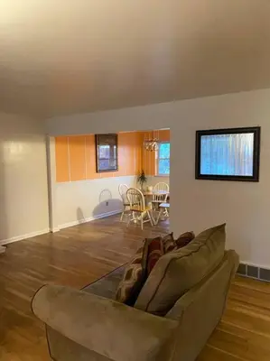 a living room with a couch and a table at Lovely home away from home 4BR 3ba in Cincinnati