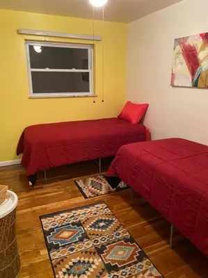 a room with two beds and a window at Lovely home away from home 4BR 3ba in Cincinnati