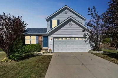 a gray house with a white garage door at Tranquil Pet Friendly Retreat residence in Reynoldsburg
