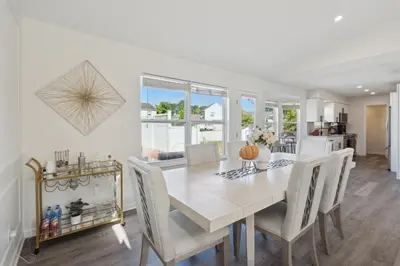 a white dining room with a table and chairs at Tranquil Pet Friendly Retreat residence in Reynoldsburg