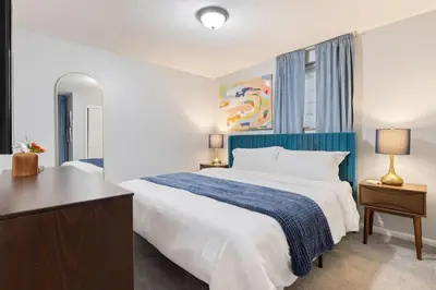 a bedroom with a large bed with a blue headboard at Maple Heights Haven - Unit 4 in Maple Heights