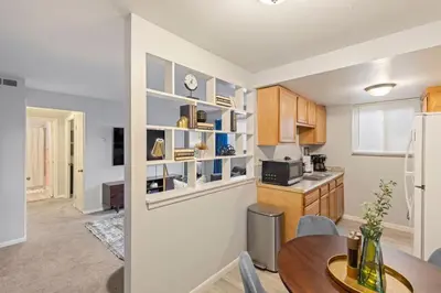 a kitchen with a table and a refrigerator at Maple Heights Haven - Unit 4 in Maple Heights