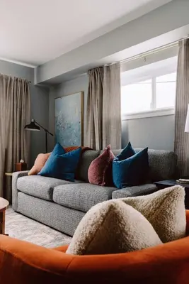 a living room with a couch with blue pillows at Westlake Elegance - Detroit Unit 3 in Westlake