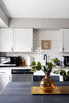 a kitchen with a vase with a plant on a table at Westlake Elegance - Detroit Unit 3 in Westlake