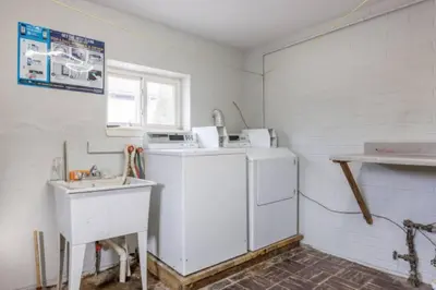 a kitchen with a white refrigerator and a sink at Westlake Elegance - Detroit Unit 3 in Westlake