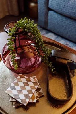 a glass vase with a plant in it on a table at Westlake Elegance - Detroit Unit 3 in Westlake