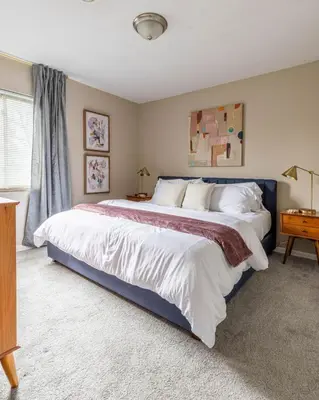 a bedroom with a large bed and a window at Maple Heights Bliss - Unit 12 in Maple Heights