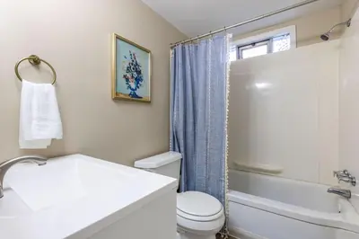 a white bathroom with a toilet and a sink at Maple Heights Bliss - Unit 12 in Maple Heights