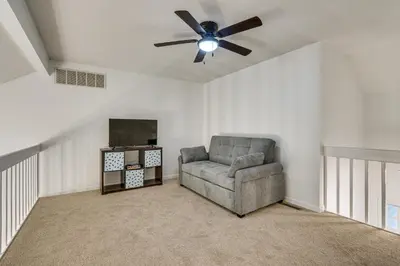 a living room with a chair and a ceiling fan at Tranquil Fort Wayne Home 7 Mi to Downtown in Fort Wayne