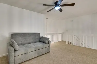 a living room with a couch and a ceiling fan at Tranquil Fort Wayne Home 7 Mi to Downtown in Fort Wayne