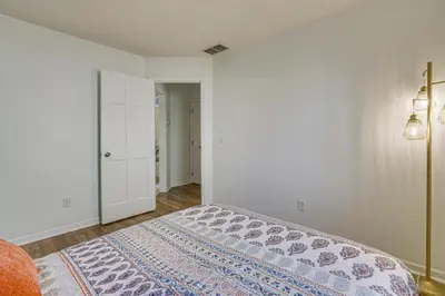 a bedroom with a bed and a white wall at Tranquil Fort Wayne Home 7 Mi to Downtown in Fort Wayne