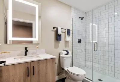 a bathroom with a toilet and a sink and a shower at King Bed, Downtown Steps from Bengals & Reds, Minutes to OTR, TQL, HardRock in Cincinnati