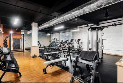 a gym with several treadmills and exercise bikes at King Bed, Downtown Steps from Bengals & Reds, Minutes to OTR, TQL, HardRock in Cincinnati