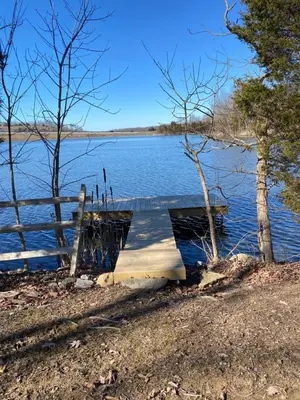 a dock on the side of a lake at Lakeside Cabin Hot tub close to Ark Encounter in Corinth