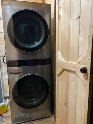 a microwave and a washer and dryer in a house at Lakeside Cabin Hot tub close to Ark Encounter in Corinth