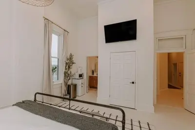 a bedroom with a bed and a tv on a wall at East Main Lofts - Minimalist 302 in Madison