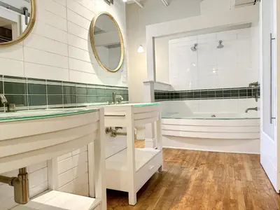 a bathroom with a tub and a sink at The Historic Lyric Presidential Suite in Cincinnati