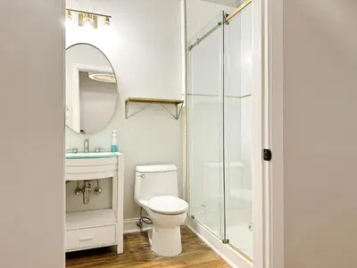 a bathroom with a toilet and a sink and a shower at The Historic Lyric Presidential Suite in Cincinnati