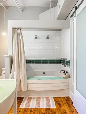 a bathroom with a tub and a sink at The Historic Lyric Presidential Suite in Cincinnati