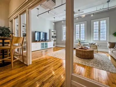 an open living room and dining room with wood floors at The Historic Lyric Presidential Suite in Cincinnati