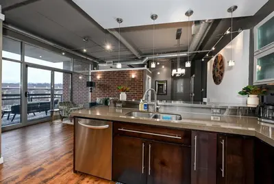 a kitchen with a sink and a large window at Luxury Condo in Akron Northside District in Akron