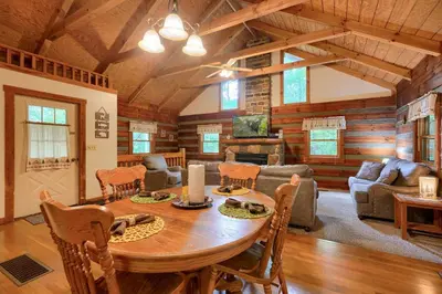 a living room with a wooden table in a cabin at Chickasaw in Logan