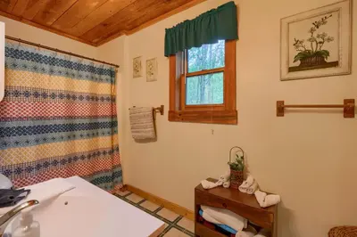 a bathroom with a sink and a window at Chickasaw in Logan