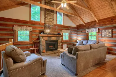 a living room with two couches and a fireplace at Chickasaw in Logan