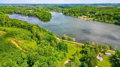 an aerial view of a river with trees at Lakewood Cottage in Logan